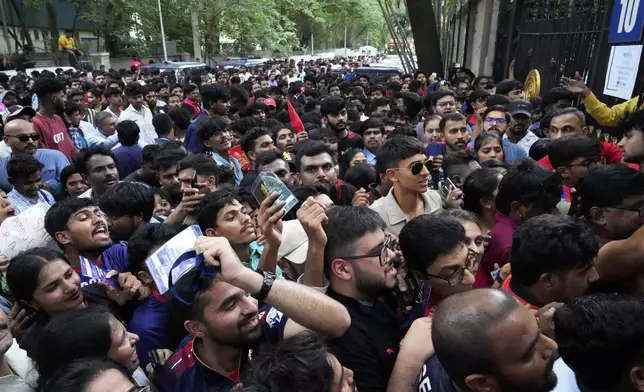 Fans wait to enter M. Chinnaswamy Stadium to celebrate Royal Challengers Bengaluru's victory in the Indian Premier League cricket tournament, in Bengaluru, India, Wednesday, June 4, 2025. (AP Photo/Aijaz Rahi)