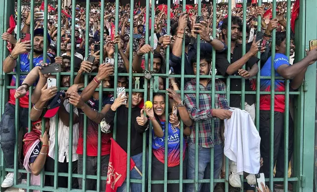 Fans gather to celebrate Royal Challengers Bengaluru cricketers, winners of the Indian Premier League, at the M. Chinnaswamy Stadium in Bengaluru, India, Wednesday, June 4, 2025. (AP Photo/Aijaz Rahi)