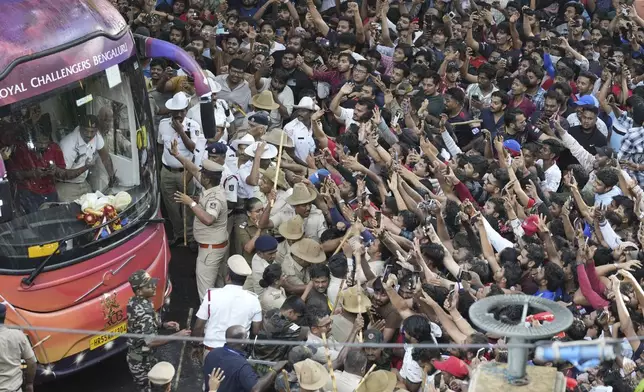 Fans cheer as the bus carrying Royal Challengers Bengaluru cricketers, winners of the Indian Premier League, arrive at the M. Chinnaswamy Stadium in Bengaluru, India, Wednesday, June 4, 2025. (AP Photo/Aijaz Rahi)