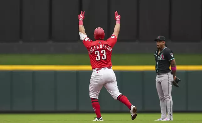 Cincinnati Reds' Christian Encarnacion-Strand gestures as he rounds the bases after hitting a three-run home run during the first inning of a baseball game against the Arizona Diamondbacks, Saturday, June 7, 2025, in Cincinnati. (AP Photo/Jeff Dean)