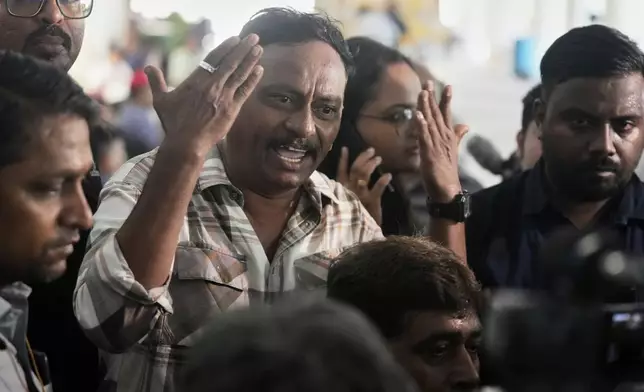 Ayub sheikh gestures angrily as he waits for the bodies of four relatives who died in the Air India plane crash, at a hospital in Ahmedabad, India, Saturday, June 14, 2025. (AP Photo/Rafiq Maqbool)
