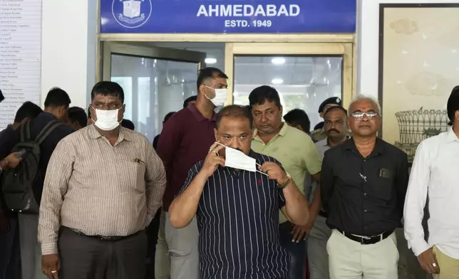 Relatives of the victims, who died in the Air India plane crash, wait outside the DNA collection center at a hospital in Ahmedabad, India, Saturday, June 14, 2025. (AP Photo/Rafiq Maqbool)