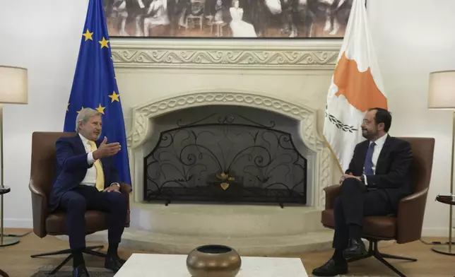 Cyprus' President Nikos Christodoulides, right, talks with the European Union special envoy for Cyprus Johannes Chan during their meeting at the presidential palace in divided capital Nicosia, Cyprus, Tuesday, June 24, 2025. (AP Photo/Petros Karadjias)