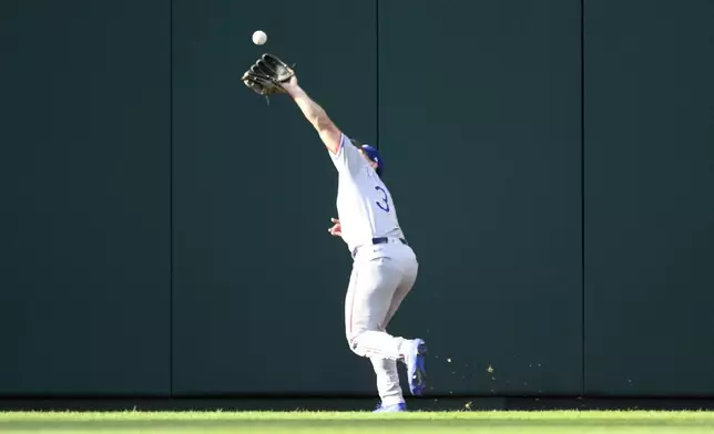 Texas Rangers center fielder Wyatt Langford (36) catches a fly ball by Washington Nationals' Luis Garcia Jr. for the out during the ninth inning of a baseball game, Saturday, June 7, 2025, in Washington. (AP Photo/Nick Wass)