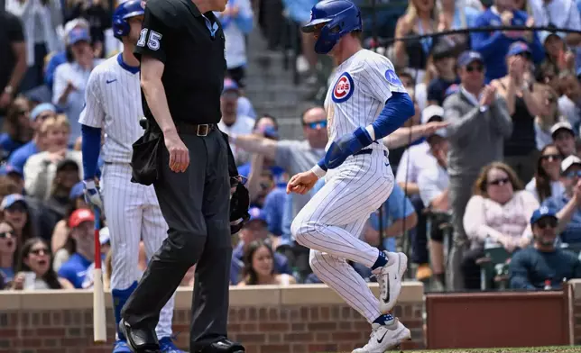 Chicago Cubs' Nico Hoerner scores during the third inning of a baseball game against the Pittsburgh Pirates, Saturday, June 14, 2025, in Chicago. (AP Photo/Matt Marton)