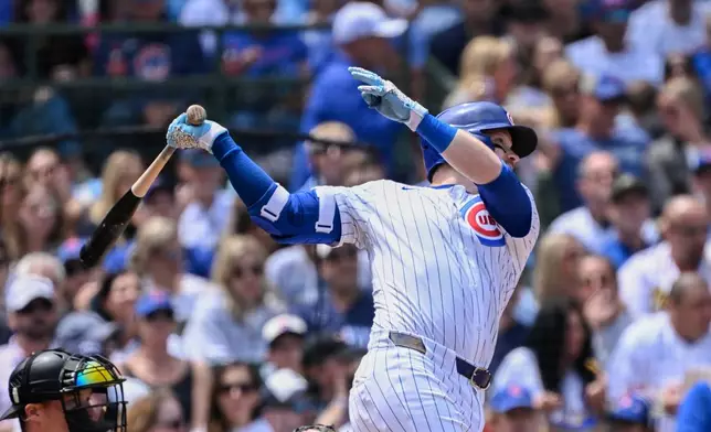 Chicago Cubs' Ian Happ hits a sacrifice fly RBI during the third inning of a baseball game against the Pittsburgh Pirates, Saturday, June 14, 2025, in Chicago. (AP Photo/Matt Marton)