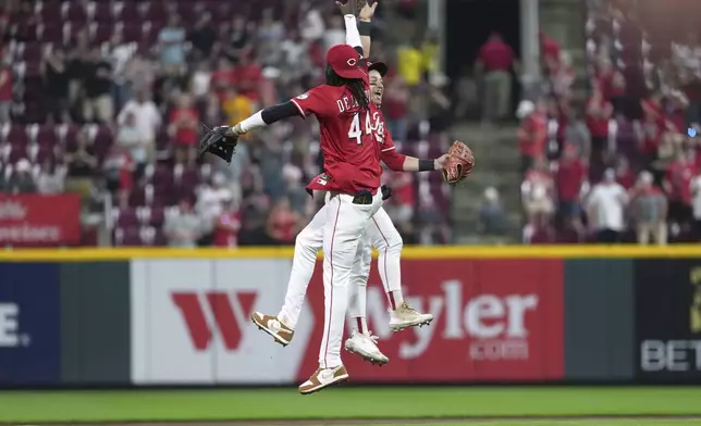 Cincinnati Reds' Elly De La Cruz, left, and TJ Friedl, right, celebrate at the conclusion of a baseball game against the Milwaukee Brewers, Tuesday, June 3, 2025, in Cincinnati. (AP Photo/Kareem Elgazzar)