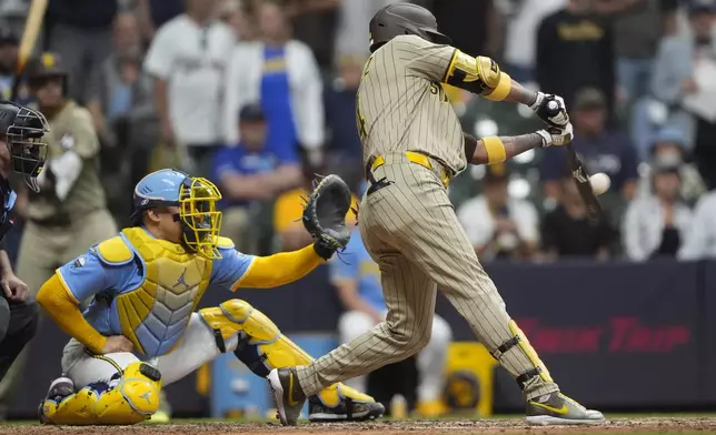 San Diego Padres' Luis Arraez hits a two-run double during the ninth inning of a baseball game against the Milwaukee Brewers, Saturday, June 7, 2025, in Milwaukee. (AP Photo/Aaron Gash)