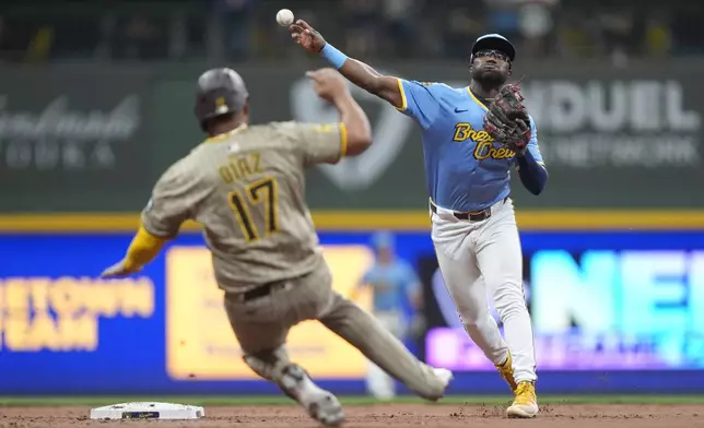 Milwaukee Brewers' Andruw Monasterio throws to first base after tagging San Diego Padres' Elias Díaz (17) out at second during the ninth inning of a baseball game Saturday, June 7, 2025, in Milwaukee. (AP Photo/Aaron Gash)