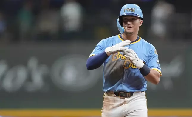 Milwaukee Brewers' Isaac Collins gestures after hitting an RBI single during the eighth inning of a baseball game against the San Diego Padres, Saturday, June 7, 2025, in Milwaukee. (AP Photo/Aaron Gash)