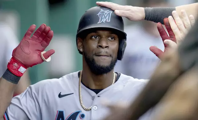 Miami Marlins' Otto Lopez celebrates in the dugout after scoring during the fourth inning of a baseball game against the Pittsburgh Pirates, Tuesday, June 10, 2025, in Pittsburgh. (AP Photo/Matt Freed)