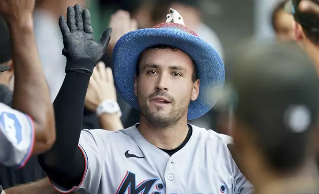 Miami Marlins' Nick Fortes celebrates in the dugout after hitting a two-run home run during the third inning of a baseball game against the Pittsburgh Pirates, Tuesday, June 10, 2025, in Pittsburgh. (AP Photo/Matt Freed)