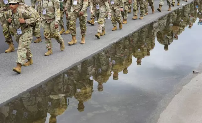 U.S. Army soldiers walking along Constitution Ave., on the National Mall ahead of a parade commemorating the Army's 250th anniversary and coinciding with President Donald Trump's 79th birthday, Saturday, June 14, 2025, in Washington. (AP Photo/Pablo Martinez Monsivais)