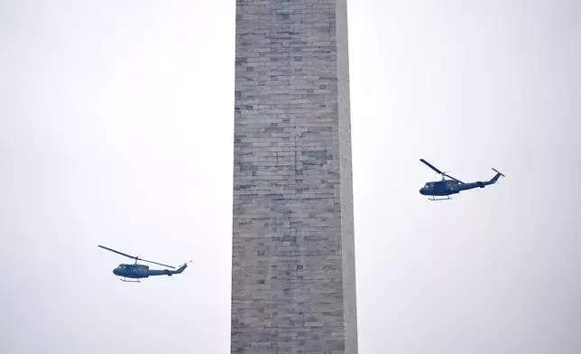 U.S. Army UH-60M Black Hawk helicopters perform a flyover during an event to honor the Army's 250th anniversary, coinciding with President Donald Trump's 79th birthday, Saturday, June 14, 2025, in Washington. (AP Photo/Mark Schiefelbein)