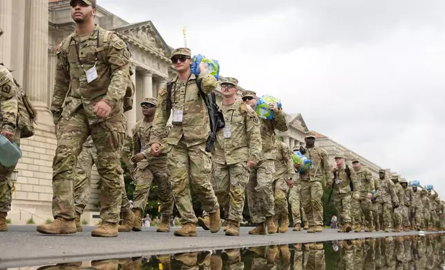 U.S. Army soldiers walking along Constitution Ave., on the National Mall ahead of a parade commemorating the Army's 250th anniversary and coinciding with President Donald Trump's 79th birthday, Saturday, June 14, 2025, in Washington. (AP Photo/Pablo Martinez Monsivais)