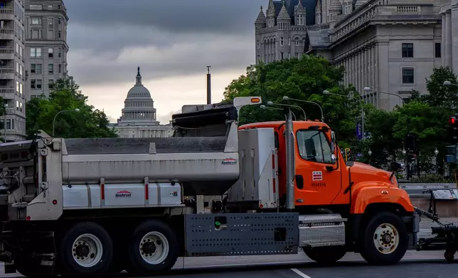 The U.S. Capitol is seen as dump trucks block an intersection ahead of an upcoming military parade commemorating the Army's 250th anniversary and coinciding with President Donald Trump's 79th birthday, Saturday, June 14, 2025, in Washington (AP Photo/Julia Demaree Nikhinson)