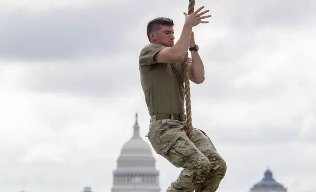 Teams warm up on the rope climb portion of the Army fitness competition, during a festival event to honor the Army's 250th anniversary and coinciding with President Donald Trump's 79th birthday, Saturday, June 14, 2025, in Washington. (AP Photo/Rod Lamkey, Jr.)