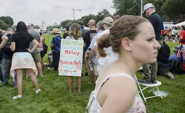 People watch a demonstration by the U.S. Army Drill Team during an event to honor the Army's 250th anniversary, coinciding with President Donald Trump's 79th birthday, Saturday, June 14, 2025, in Washington. (AP Photo/Rod Lamkey, Jr.)