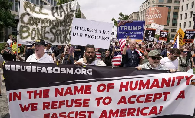 Demonstrators rally near Lafayette Park during a demonstration against President Donald Trump policies in Washington, Saturday, June 14, 2025. (AP Photo/Jose Luis Magana)