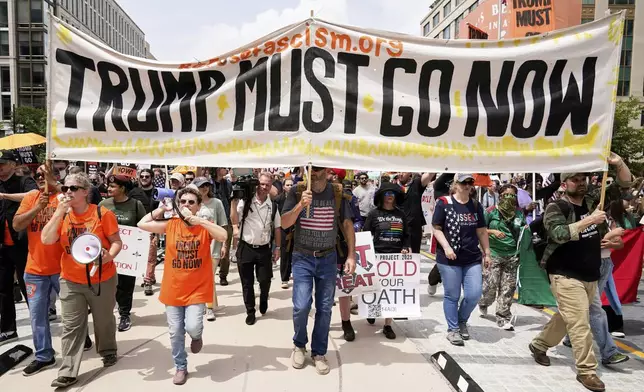 Demonstrators rally at Lafayette park during a demonstration against President Donald Trump policies in Washington, Saturday, June 14, 2025. (AP Photo/Jose Luis Magana)