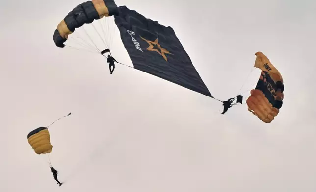U.S. Army Parachute Team, nicknamed the Golden Knights, participate in the Army's 250th anniversary ceremony, coinciding with President Donald Trump's 79th birthday, Saturday, June 14, 2025, in Washington. (AP Photo/Jacquelyn Martin)
