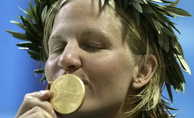 FILE -Kirsty Coventry, of Zimbabwe, kisses her gold medal after winning the 200-meter backstroke at the Olympic Aquatic Centre during the 2004 Olympic Games in Athens, Aug. 20, 2004. (AP Photo/Mark Baker), File)
