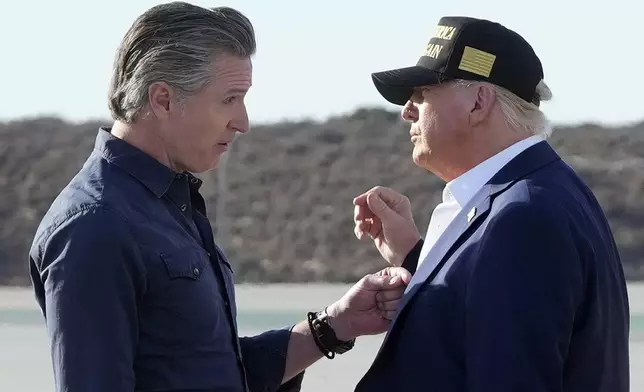 FILE - President Donald Trump talks with California Gov. Gavin Newsom after arriving on Air Force One at Los Angeles International Airport in Los Angeles, Jan. 24, 2025. (AP Photo/Mark Schiefelbein, File)