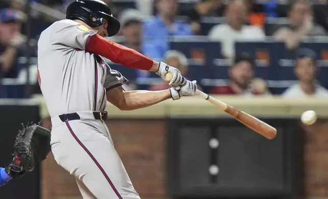 Atlanta Braves' Matt Olson hits a two-run single during the sixth inning of a baseball game against the New York Mets Tuesday, June 24, 2025, in New York. (AP Photo/Frank Franklin II)