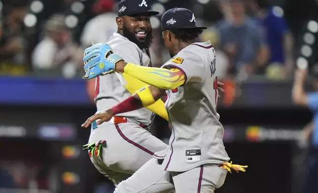 Atlanta Braves' Marcell Ozuna, left, celebrates with Ronald Acuña after a baseball game against the New York Mets Tuesday, June 24, 2025, in New York. (AP Photo/Frank Franklin II)