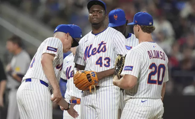 New York Mets manager Carlos Mendoza takes the ball from New York Mets pitcher Huascar Brazobán during the sixth inning of a baseball game against the Atlanta Braves Tuesday, June 24, 2025, in New York. (AP Photo/Frank Franklin II)