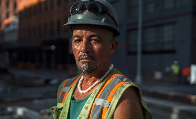 Construction worker Tony Martins, 49, sweats as he stands for a portrait during a heatwave on Tuesday, June 24, 2025, in New York. (AP Photo/Olga Fedorova)