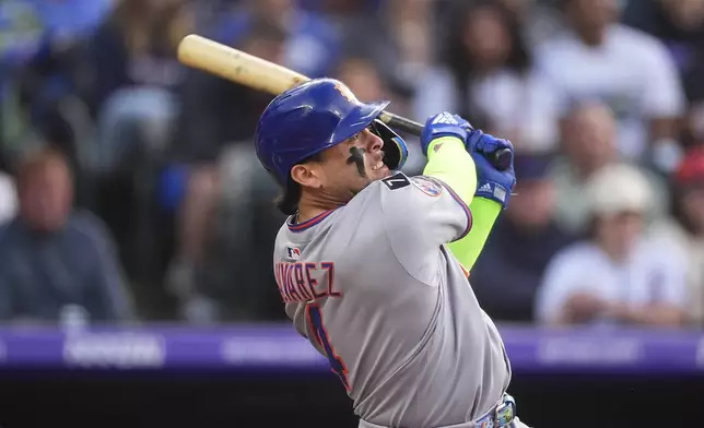 New York Mets' Francisco Alvarez singles in the second inning of a baseball game against the Colorado Rockies Friday, June 6, 2025, in Denver. (AP Photo/David Zalubowski)