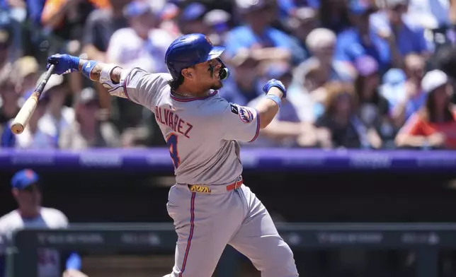 New York Mets' Francisco Alvarez follows the flight of his RBI single off Colorado Rockies starting pitcher Chase Dollander in the second inning of a baseball game, Sunday, June 8, 2025, in Denver. (AP Photo/David Zalubowski)