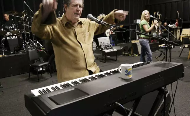 FILE - Brain Wilson, leader of The Beach Boys, performs the song "Heroes and Villains" during a rehearsal at a sound stage in Burbank, Calif., Sept. 22, 2004. (AP Photo/Kevork Djansezian, File)