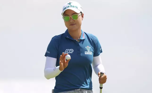 Minjee Lee waves her ball after sinking a putt on the first green during the final round of the Women's PGA Championship golf tournament Sunday, June 22, 2025, in Frisco, Texas. (AP Photo/LM Otero)