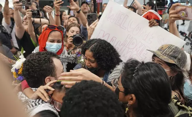 Mahmoud Khalil, left, is greeted by supporters upon arriving at Newark International Airport, Saturday, June 21, 2025, in Newark, N.J. (AP Photo/Seth Wenig)