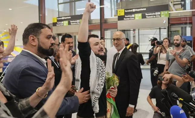 Mahmoud Khalil, center, reacts as he is greeted upon arriving at Newark International Airport, Saturday, June 21, 2025, in Newark, N.J. (AP Photo/Seth Wenig)