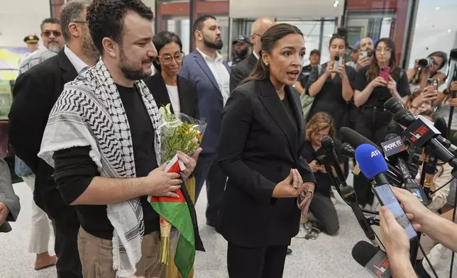 Rep. Alexandria Ocasio-Cortez, D-N.Y., speaks during a news conference after Mahmoud Khalil, left, arrived at Newark International Airport, Saturday, June 21, 2025, in Newark, N.J. (AP Photo/Seth Wenig)