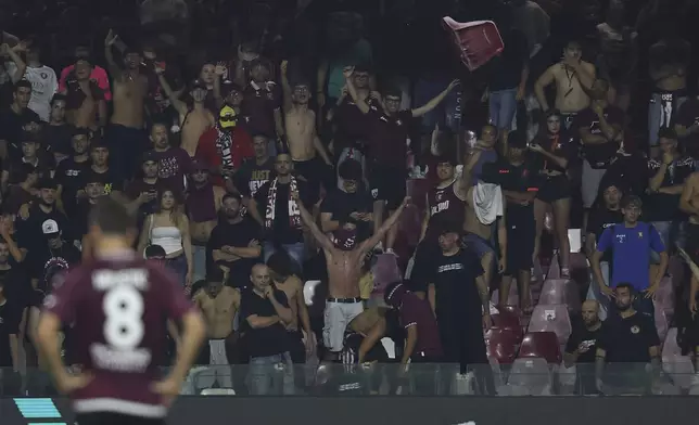 A seat is thrown by the Salernitana fans during a playoff between Sampdoria and Salernitana to stay in Serie B which caused the suspension of the match, at the at the Arechi Stadium in Salerno, southern Italy, Sunday, July 22, 2025. (Alessandro Garofalo/LaPresse via AP)