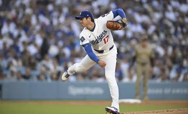 Los Angeles Dodgers starting pitcher Shohei Ohtani throws to a San Diego Padres batter during the first inning of a baseball game Monday, June 16, 2025, in Los Angeles. (AP Photo/Kyusung Gong)