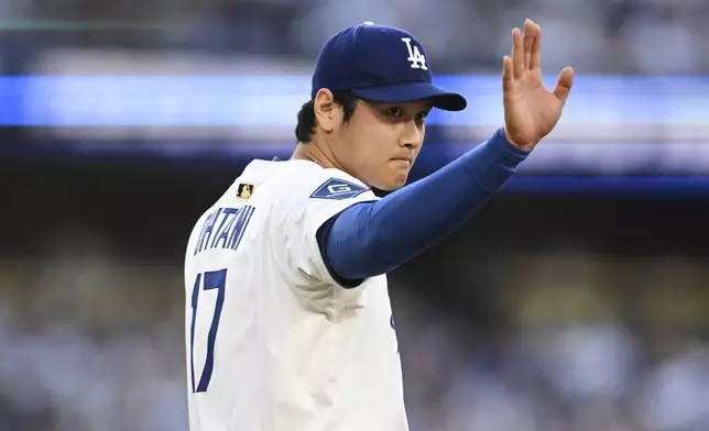 Los Angeles Dodgers starting pitcher Shohei Ohtani waves near the mound during the first inning of a baseball game against the San Diego Padres, Monday, June 16, 2025, in Los Angeles. (AP Photo/Kyusung Gong)