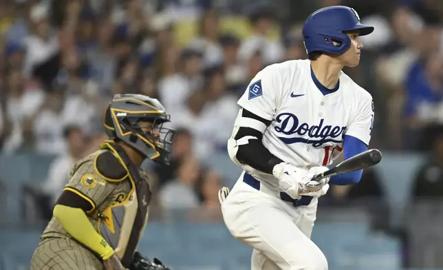 Los Angeles Dodgers' Shohei Ohtani drives in a run with a double during the third inning of a baseball game against the San Diego Padres, Monday, June 16, 2025, in Los Angeles. (AP Photo/Kyusung Gong)