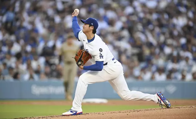 Los Angeles Dodgers starting pitcher Shohei Ohtani throws to a San Diego Padres batter during the first inning of a baseball game Monday, June 16, 2025, in Los Angeles. (AP Photo/Kyusung Gong)