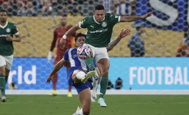 Palmeiras' Paulinho, front, is fouled by Porto's Nehuen Perez during the Club World Cup group A soccer match between Palmeiras and FC Porto in East Rutherford, NJ, Sunday, June 15, 2025. (AP Photo/Adam Hunger)