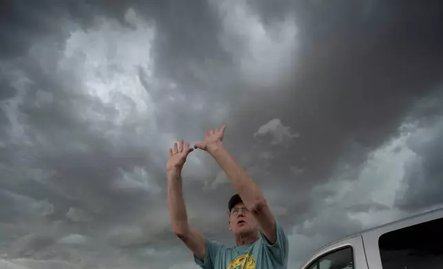 National Weather Service forecaster David Imy gestures to an approaching storm during a Project ICECHIP operation Tuesday, June 3, 2025, near Tipton, Okla. (AP Photo/Carolyn Kaster)