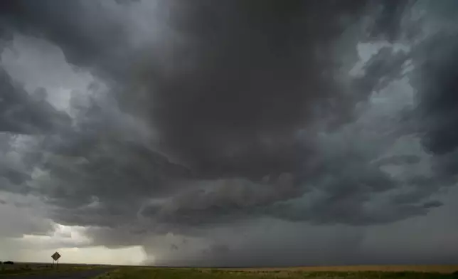 An approaching storm and rain shaft is visible during a Project ICECHIP operation Tuesday, June 3, 2025, near Tipton, Okla. (AP Photo/Carolyn Kaster)