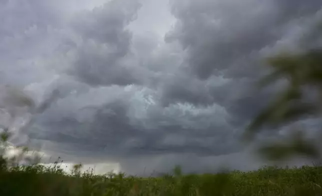 An approaching storm and rain shaft is visible during a Project ICECHIP operation Tuesday, June 3, 2025, near Tipton, Okla. (AP Photo/Carolyn Kaster)