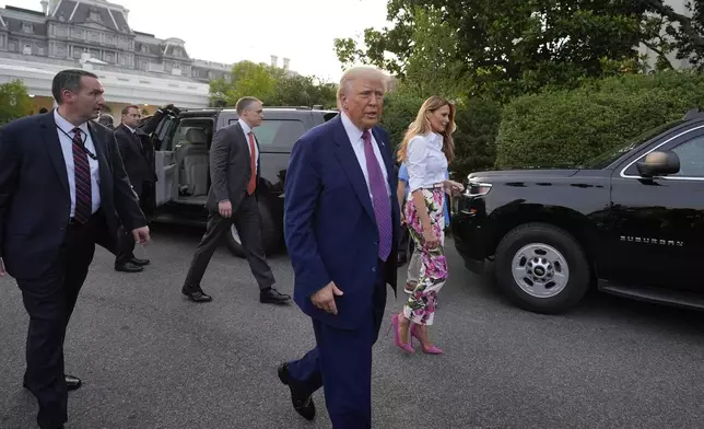 President Donald Trump and first lady Melania Trump walk after greeting guests during the congressional picnic on the South Lawn of the White House, Thursday, June 12, 2025, in Washington. (AP Photo/Alex Brandon)