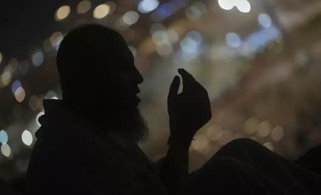 A Muslim pilgrim prays during the annual Hajj pilgrimage on the Plain of Arafat, near the holy city of Mecca, Saudi Arabia, Thursday, June 5, 2025. (AP Photo/Amr Nabil)