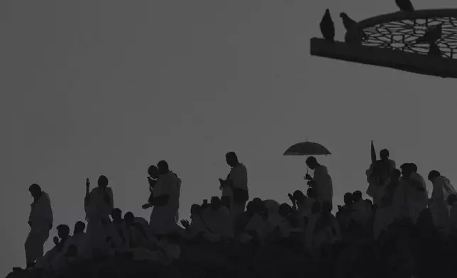 Muslim pilgrims gather a top of the rocky hill known as the Mountain of Mercy, on the Plain of Arafat, during the annual Hajj pilgrimage near the holy city of Mecca, Saudi Arabia, Thursday, June 5, 2025. (AP Photo/Amr Nabil)